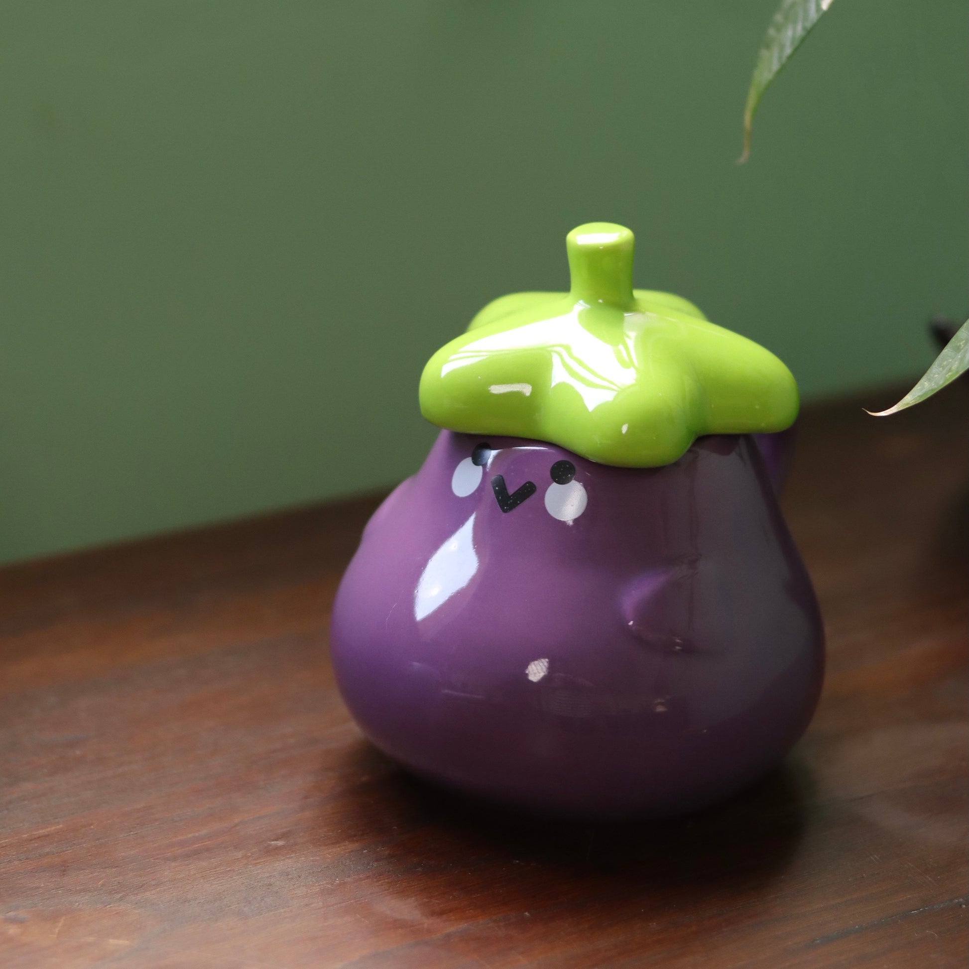 Ceramic teapot with red polka dot lid and fox design, being used to pour tea into a matching cup and saucer.