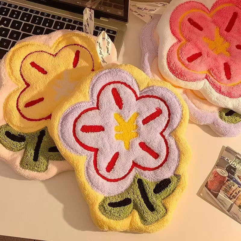 Flower Hand Towel-Floral design phone cases on a desk with a laptop in the background