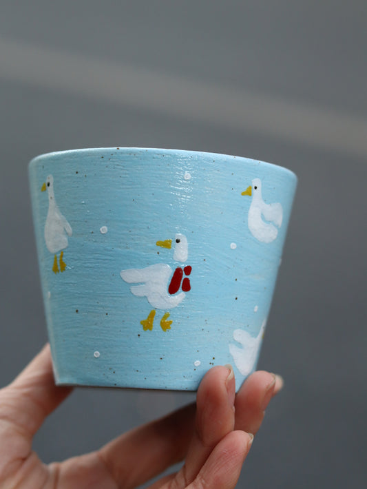 Goose Parade ceramic cup with hand-painted geese