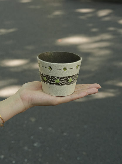 Hand-painted green ceramic cup with star pattern and textured finish