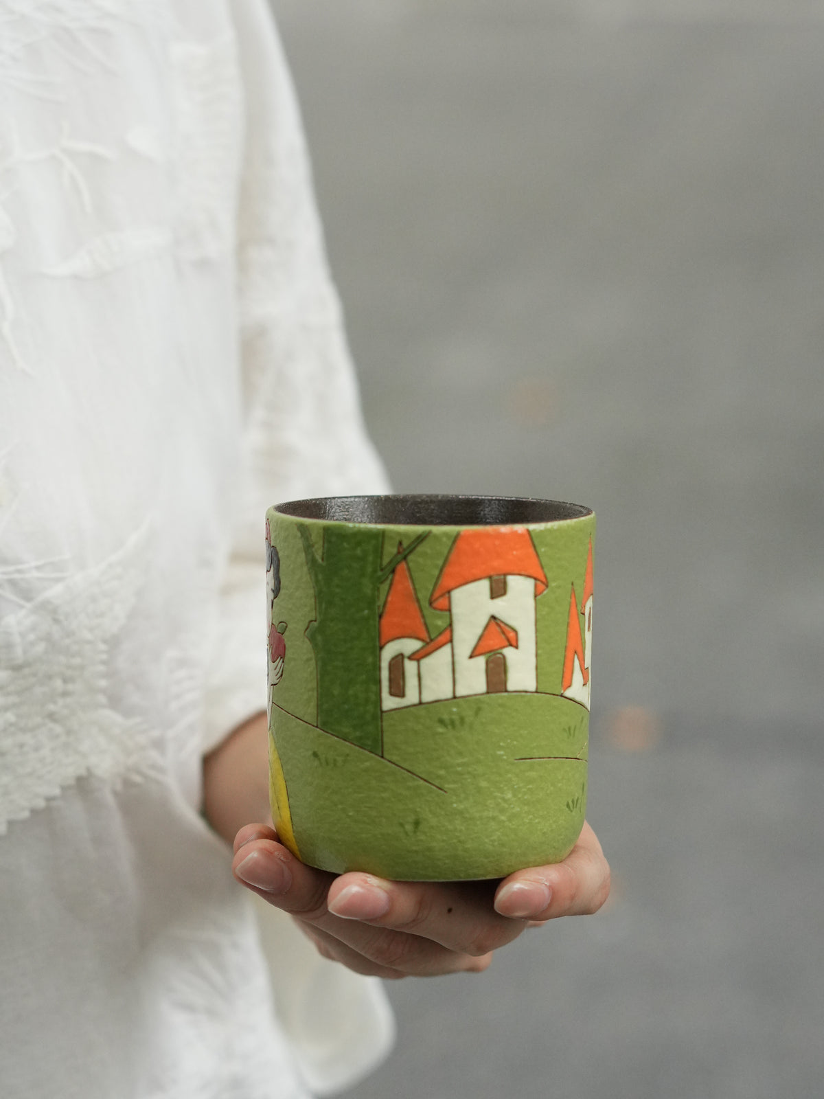 Snow White ceramic cup showing the wraparound green landscape and orange-roofed storybook castle.