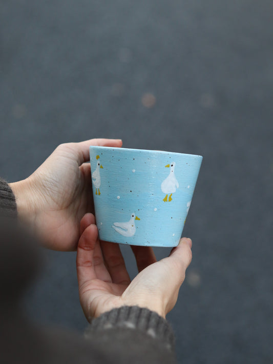 Hand-painted goose illustration on ceramic cup