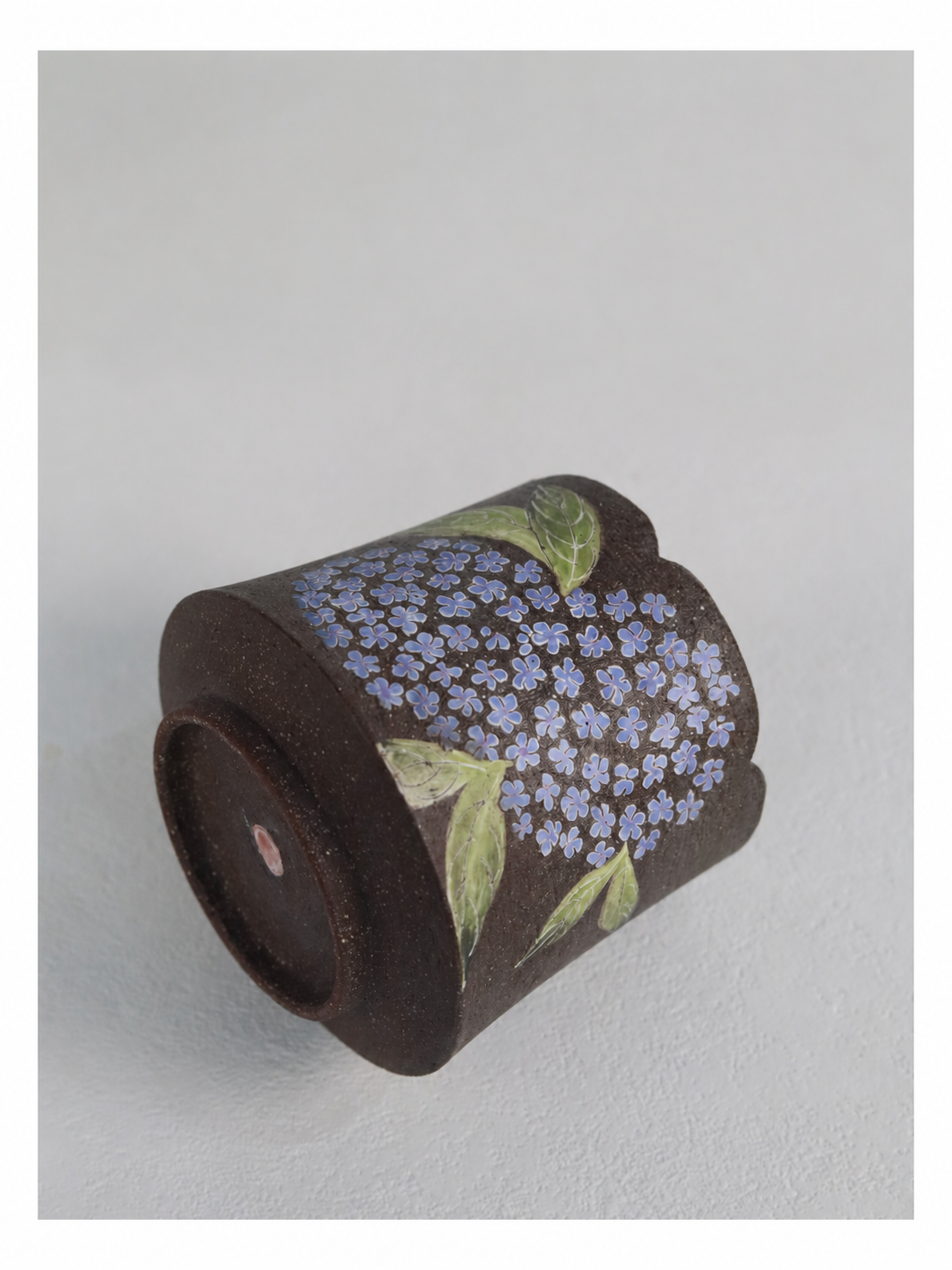 Detailed close-up of the individually coloured hydrangea flowers and carved texture.