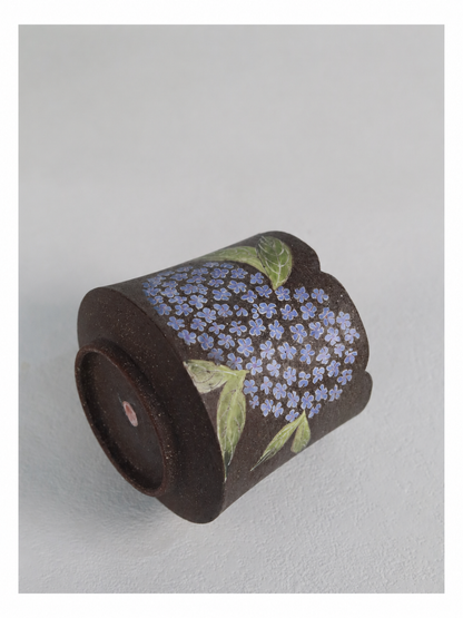 Detailed close-up of the individually coloured hydrangea flowers and carved texture.