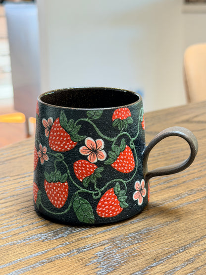 Decorative keychain with strawberry pattern on a wooden surface