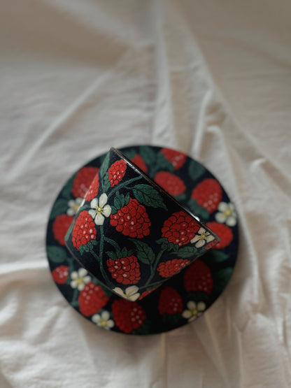 Decorative box with strawberry pattern on a white fabric background