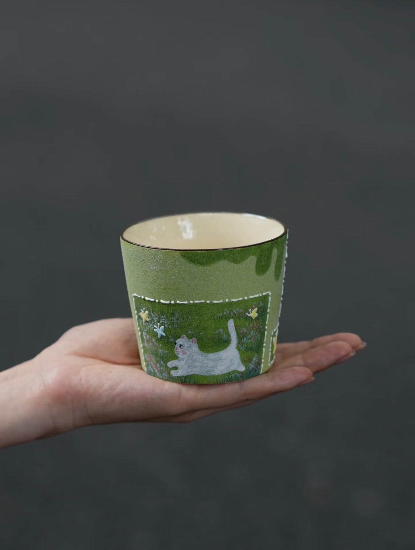 Butterfly Chase hand-painted cat ceramic cup with textured green finish
