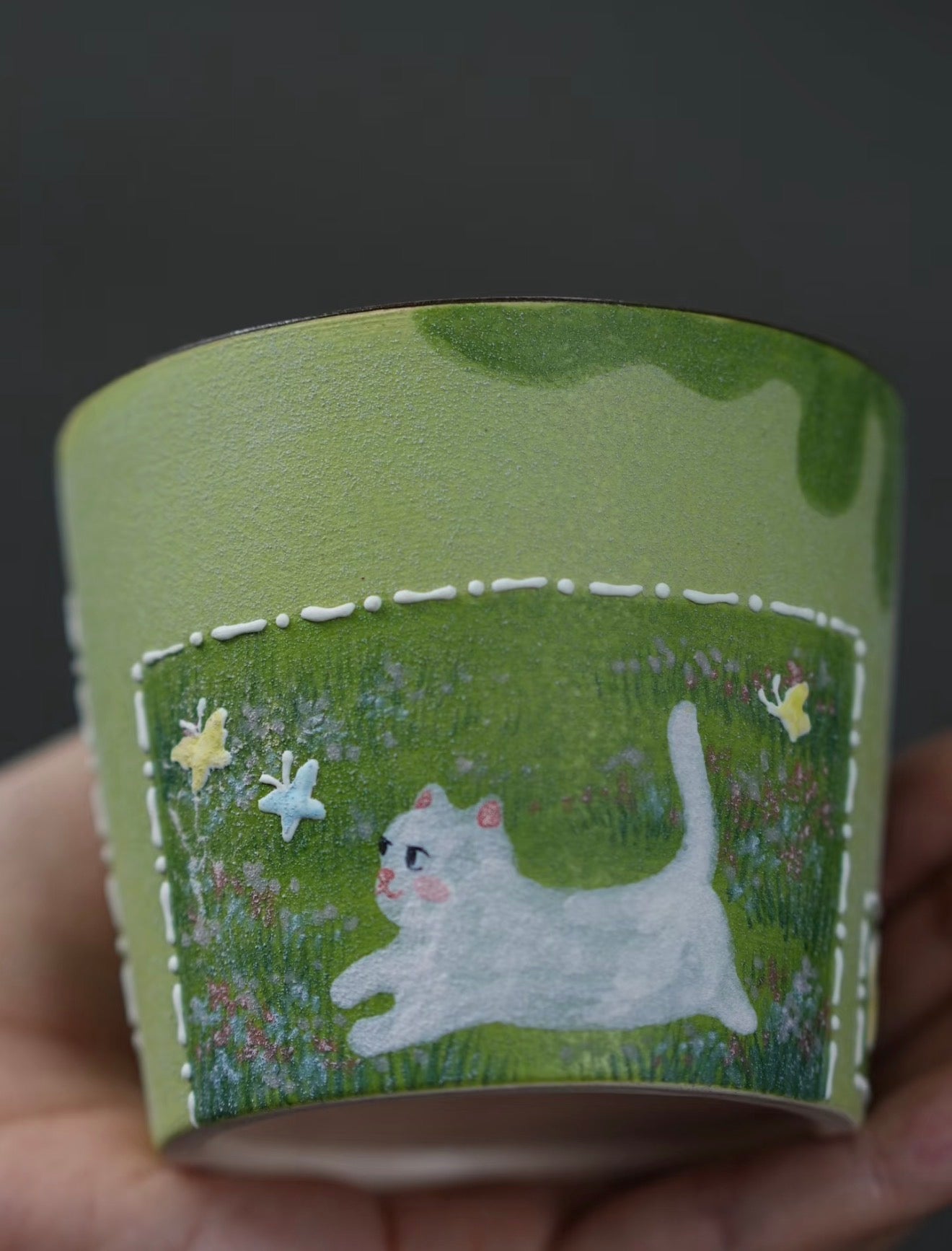 Side view of the 250ml green hand-painted ceramic cup