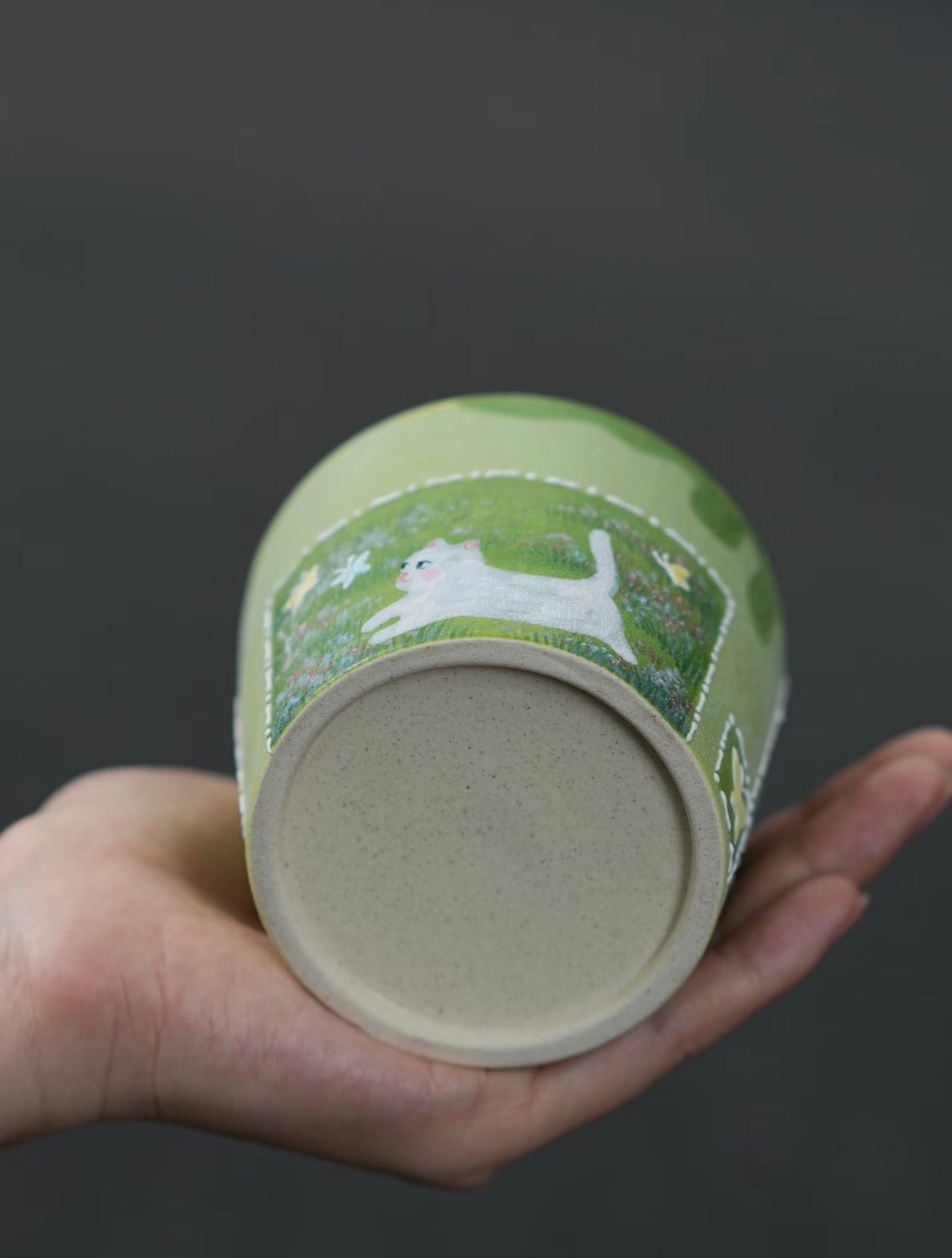 Base view of the Butterfly Chase hand-painted ceramic cup