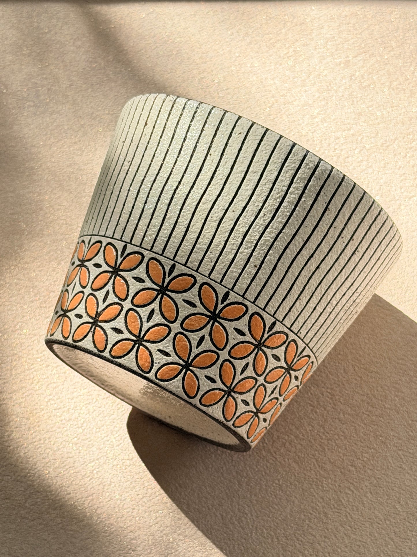 Hand-carved 270ml ceramic cup with orange floral band and fine black vertical stripes