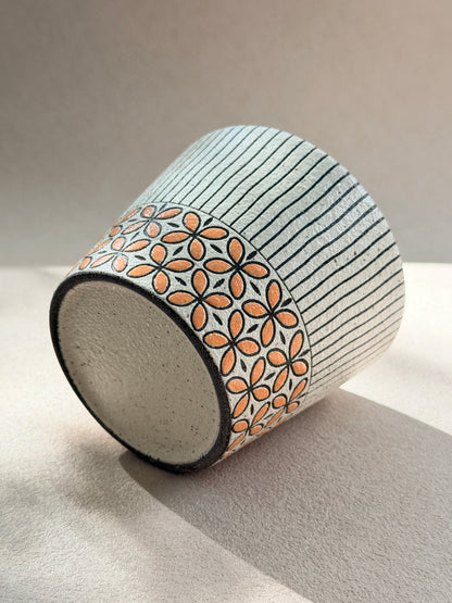 Hand-carved 270ml ceramic cup with orange floral band and fine black vertical stripes