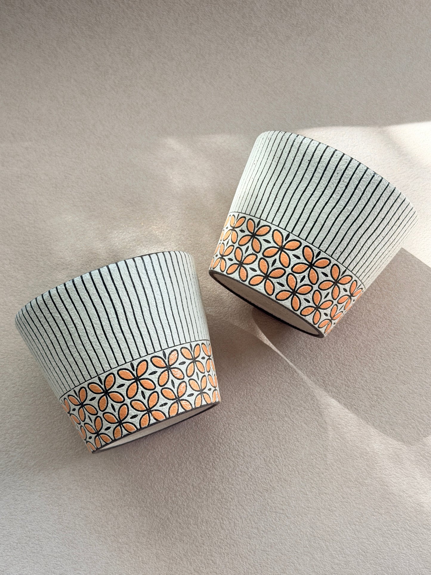 Hand-carved 270ml ceramic cup with orange floral band and fine black vertical stripes