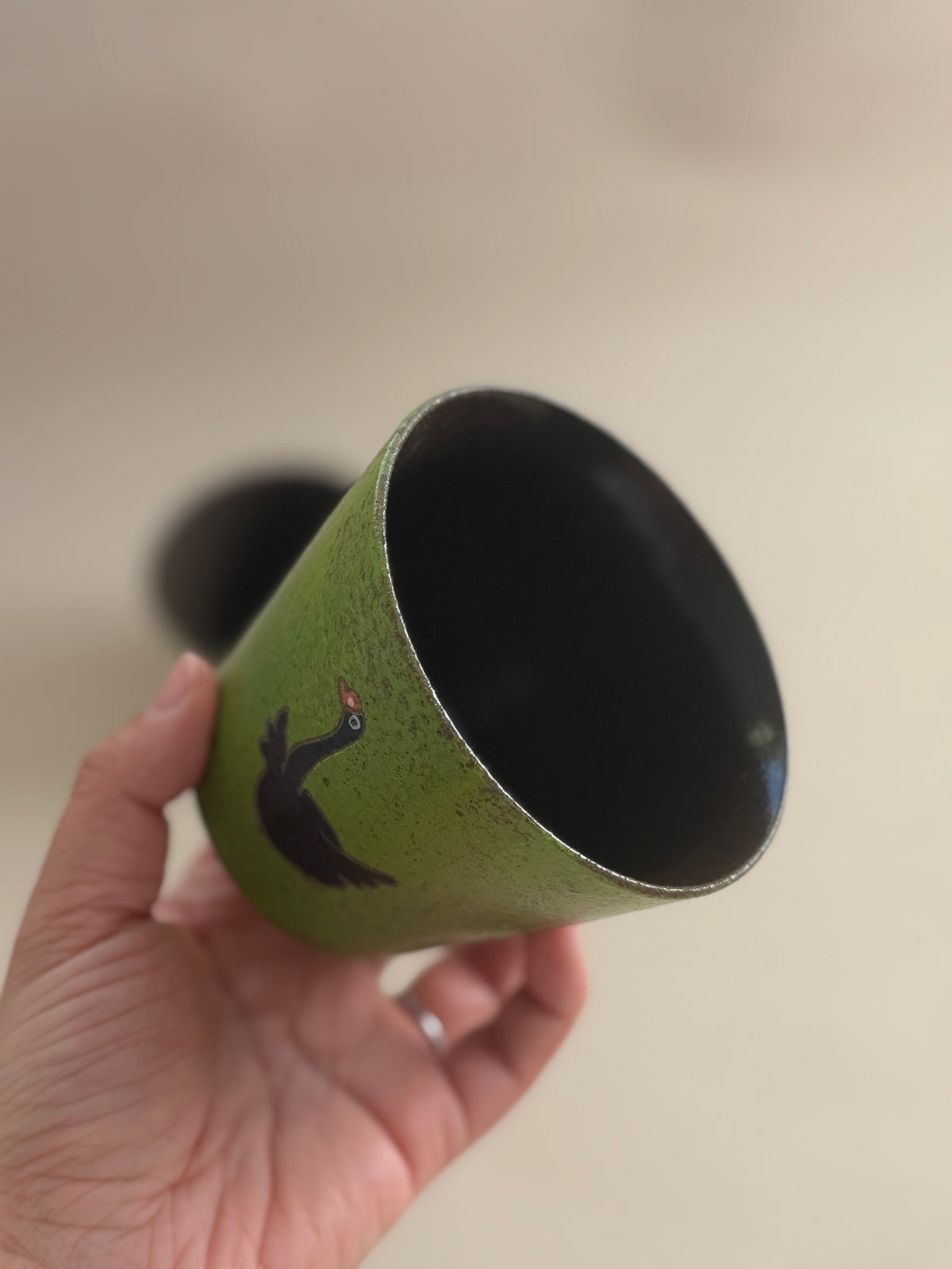 Angled view of the black goose cup showing its dark glazed interior.