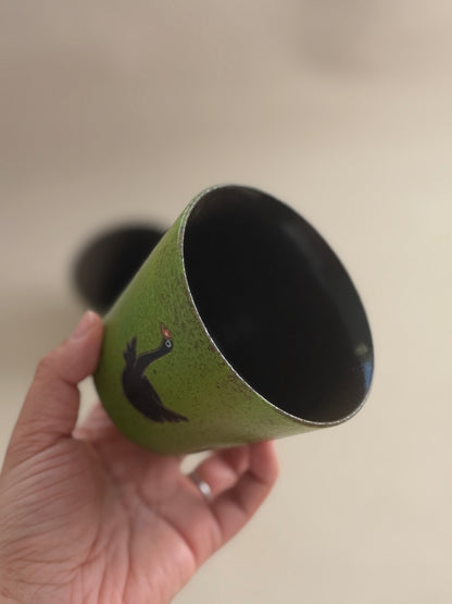 Angled view of the black goose cup showing its dark glazed interior.