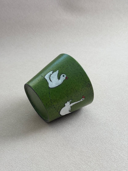 Angled side view of the white goose cup on a neutral background.