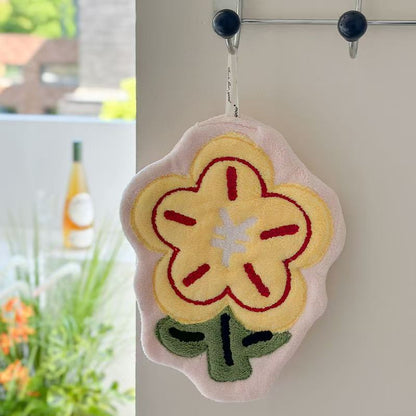 Flower Hand Towel-Floral-shaped decorative item hanging on a hook with a blurred outdoor background