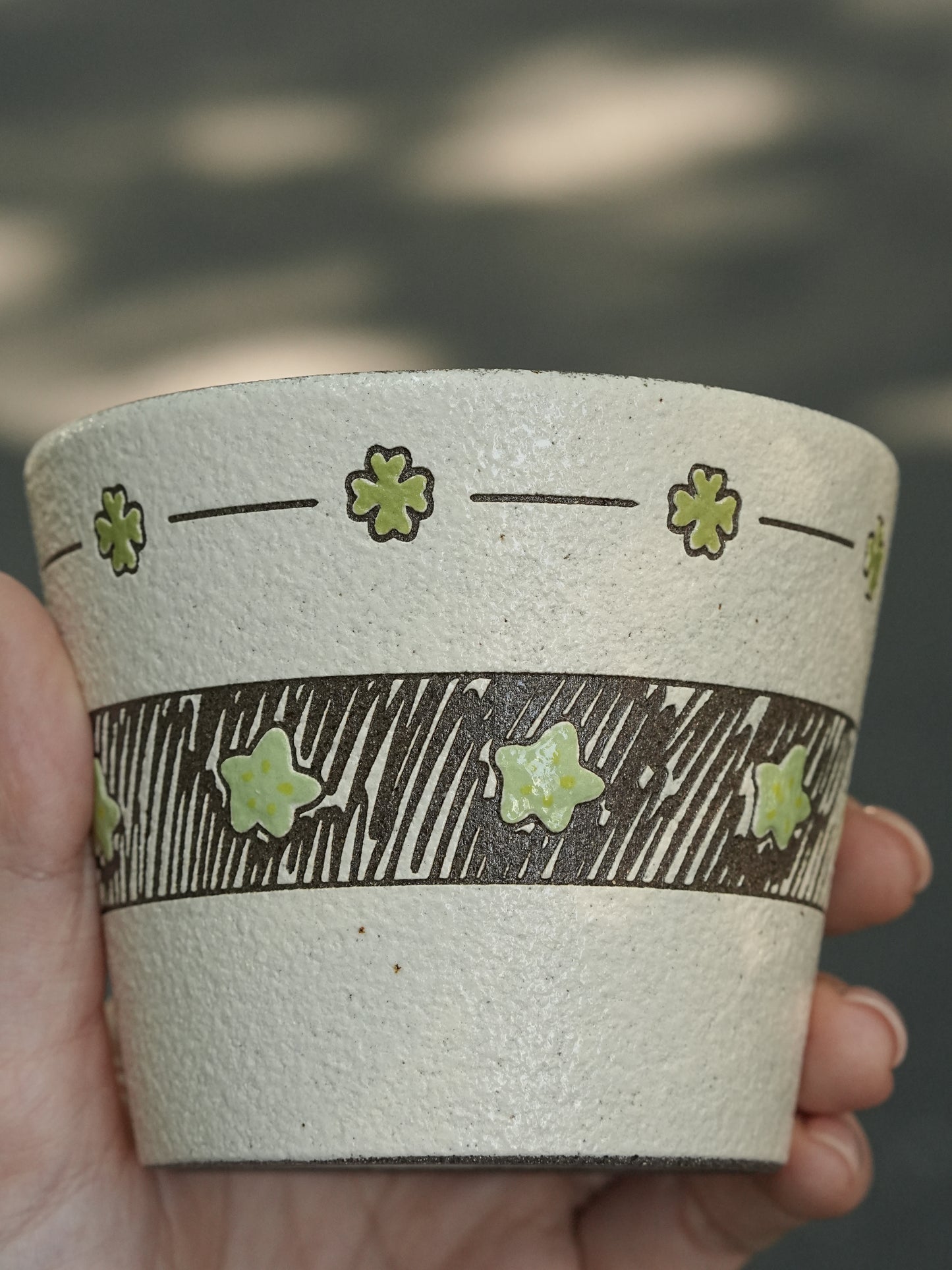 Hand-painted green ceramic cup with star pattern and textured finish