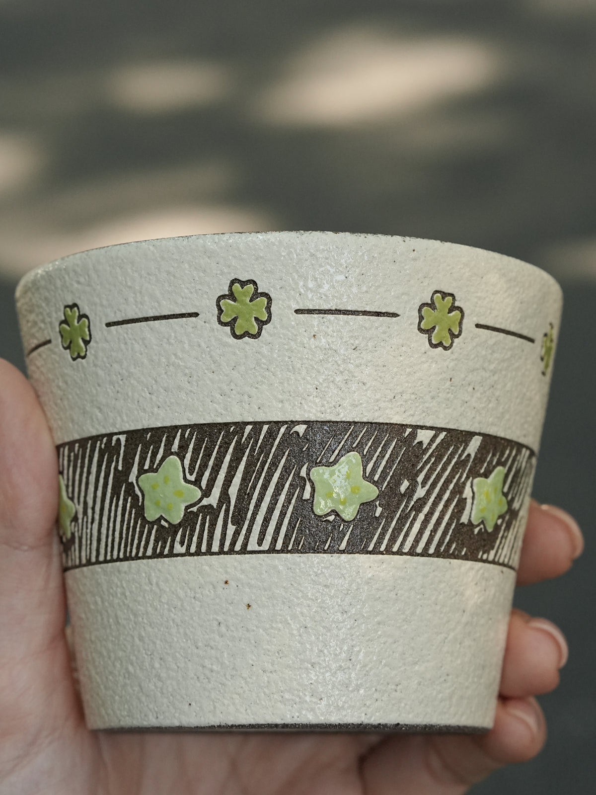 Hand-painted green ceramic cup with star pattern and textured finish