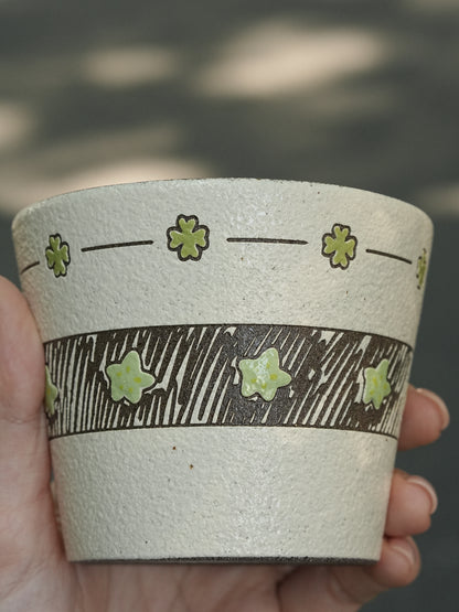 Hand-painted green ceramic cup with star pattern and textured finish